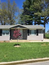 Duplex home with pink flowering tree in front yard